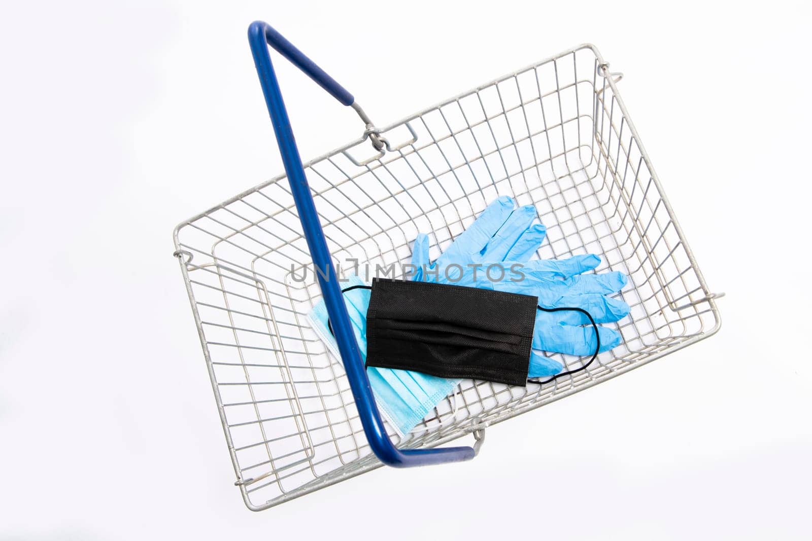Shopping basket with mouth protection and hand gloves, top view, isolated on white background