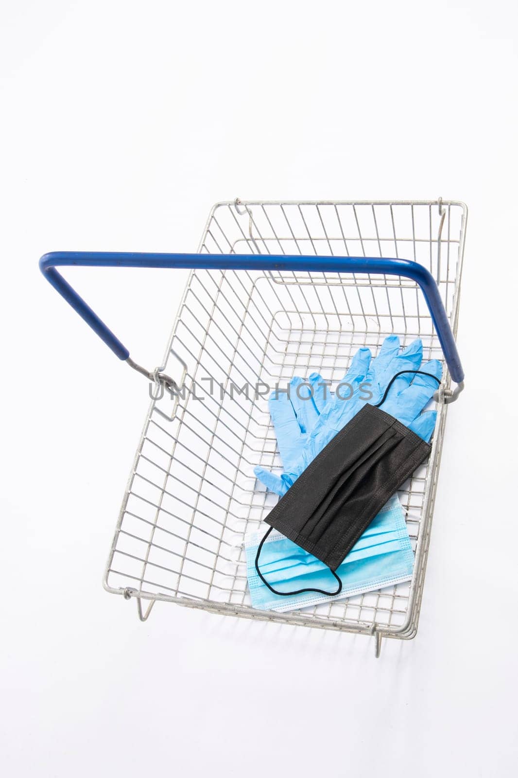 Shopping basket with mouth protection and hand gloves, isolated on white background