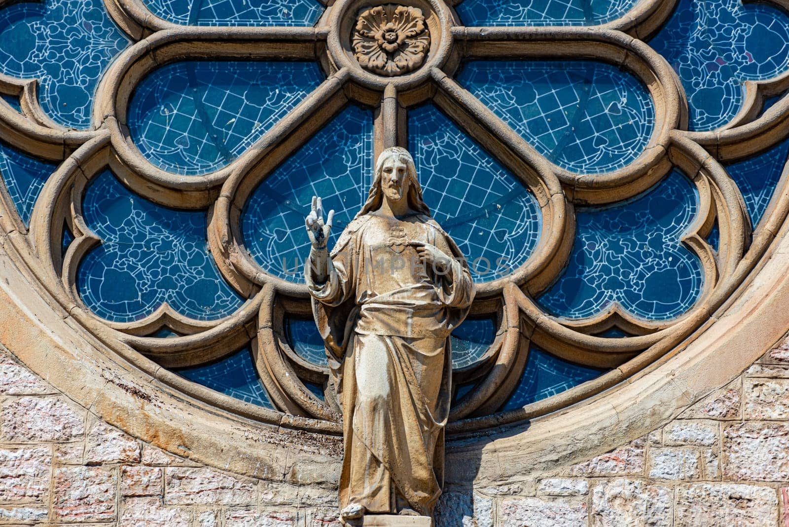 Cathedral window and statue of christ in Sarajevo, Bosnia Herzegovina, Europe. Architecture and travel.