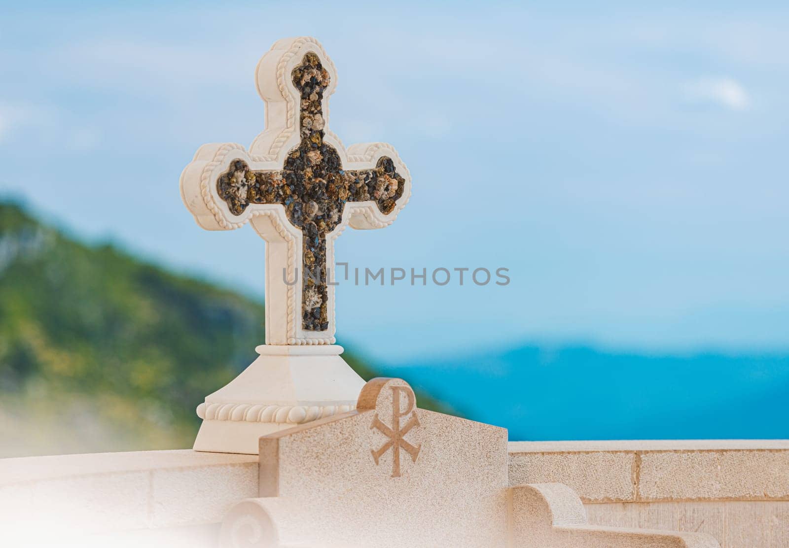 Cross in Monastery Ostrog of the Serbian Orthodox Church against blue sky and mountain. Montenegro travel, Europe.