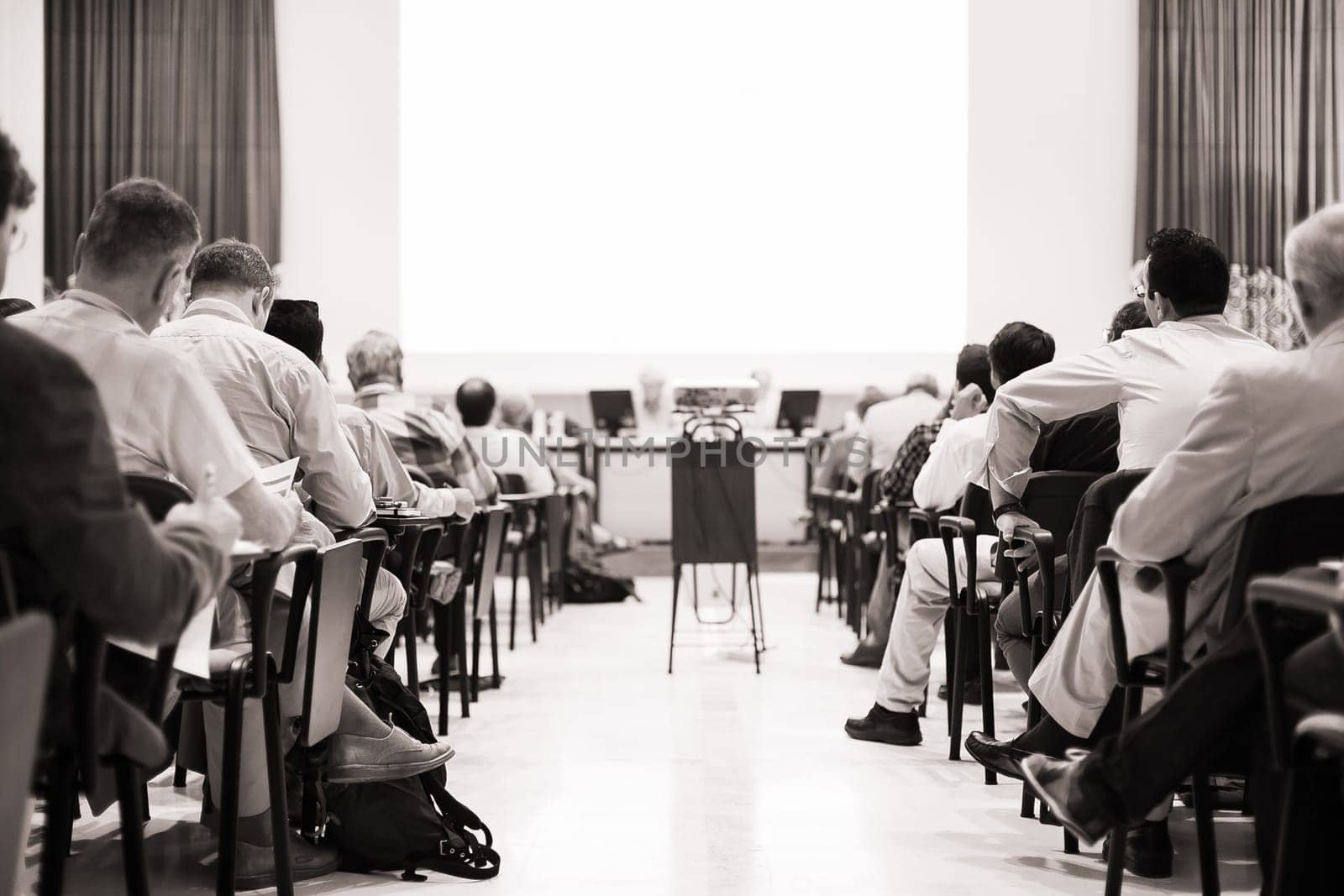 Business Conference and Presentation. Audience at the conference hall. Business and Entrepreneurship. Black and white image.