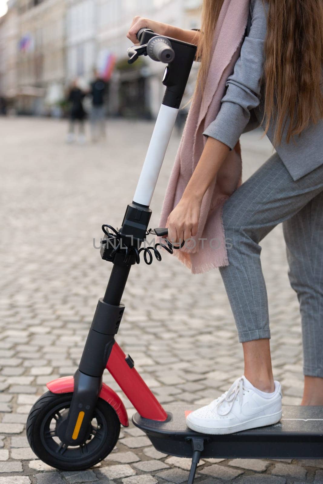 User unlocking rental electric scooter. Eco friendly green modern urban mobility concept of sharing transportation with electric scooters for rent in Ljubljana, Slovenia.