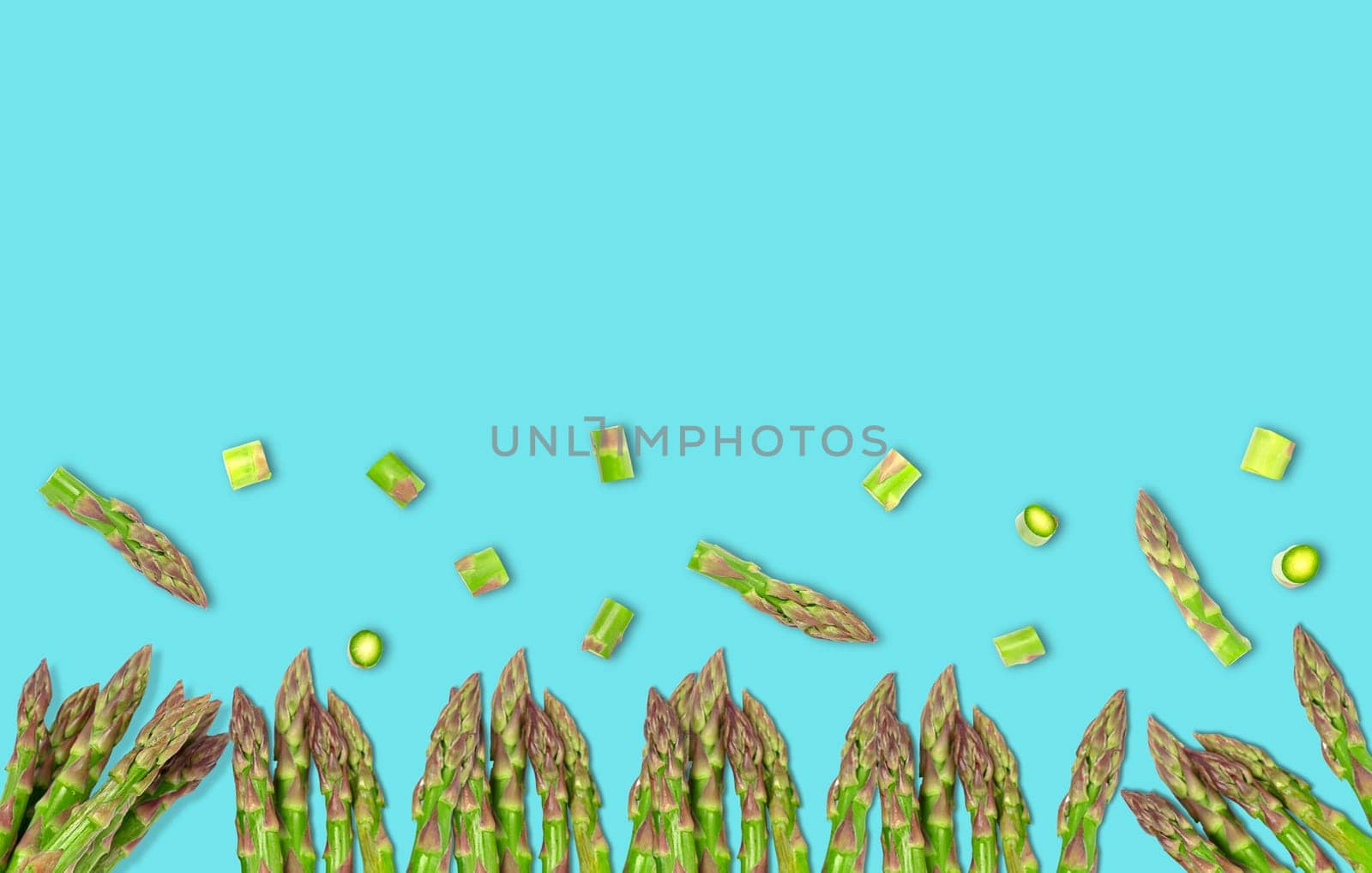 Isolated vegetable. Raw cut asparagus. top view isolated on light blue background. Panorama website header banner. High quality photo.