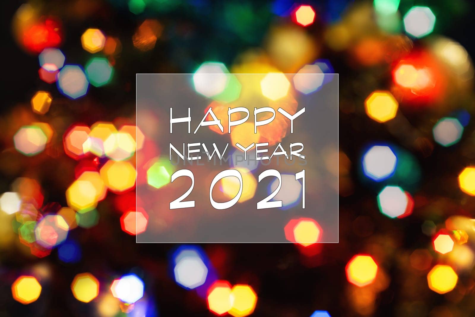 Happy New Year 2021 greeting card, blurred background of the twinkling lights of the Christmas tree. Greeting card background.