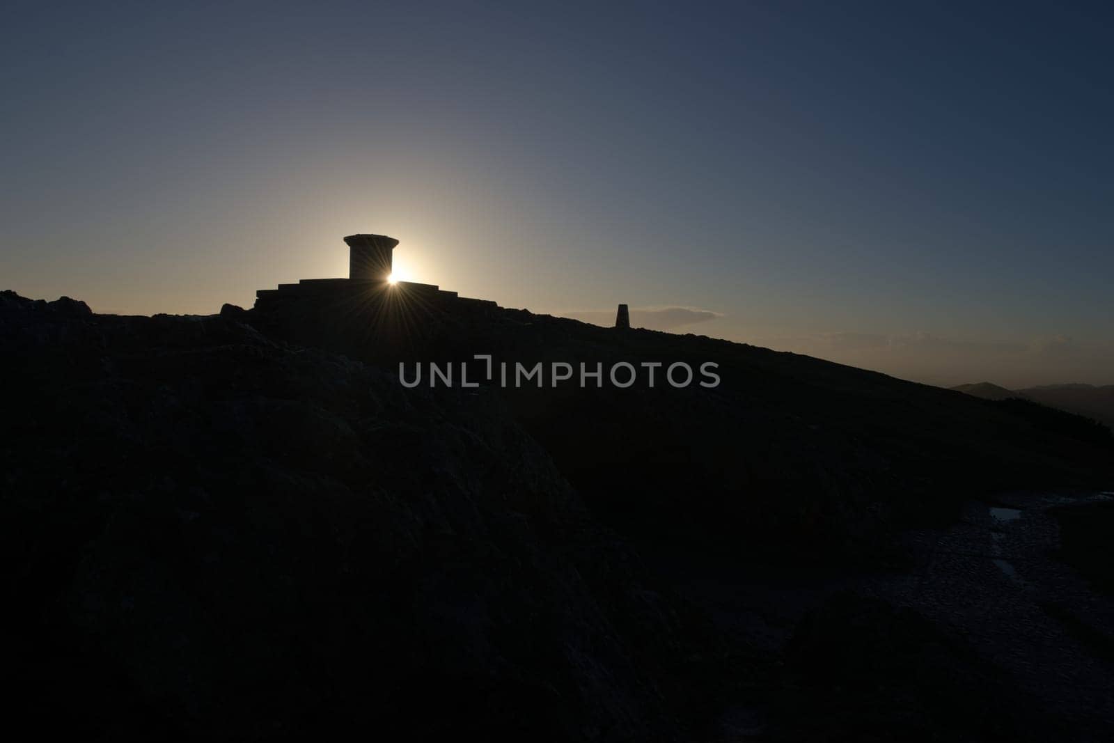 6 - Wide angle silhouette of the worcestershire beacon summit at sunrise. Part of the malvern hills, plenty of black copy space in the lower half.