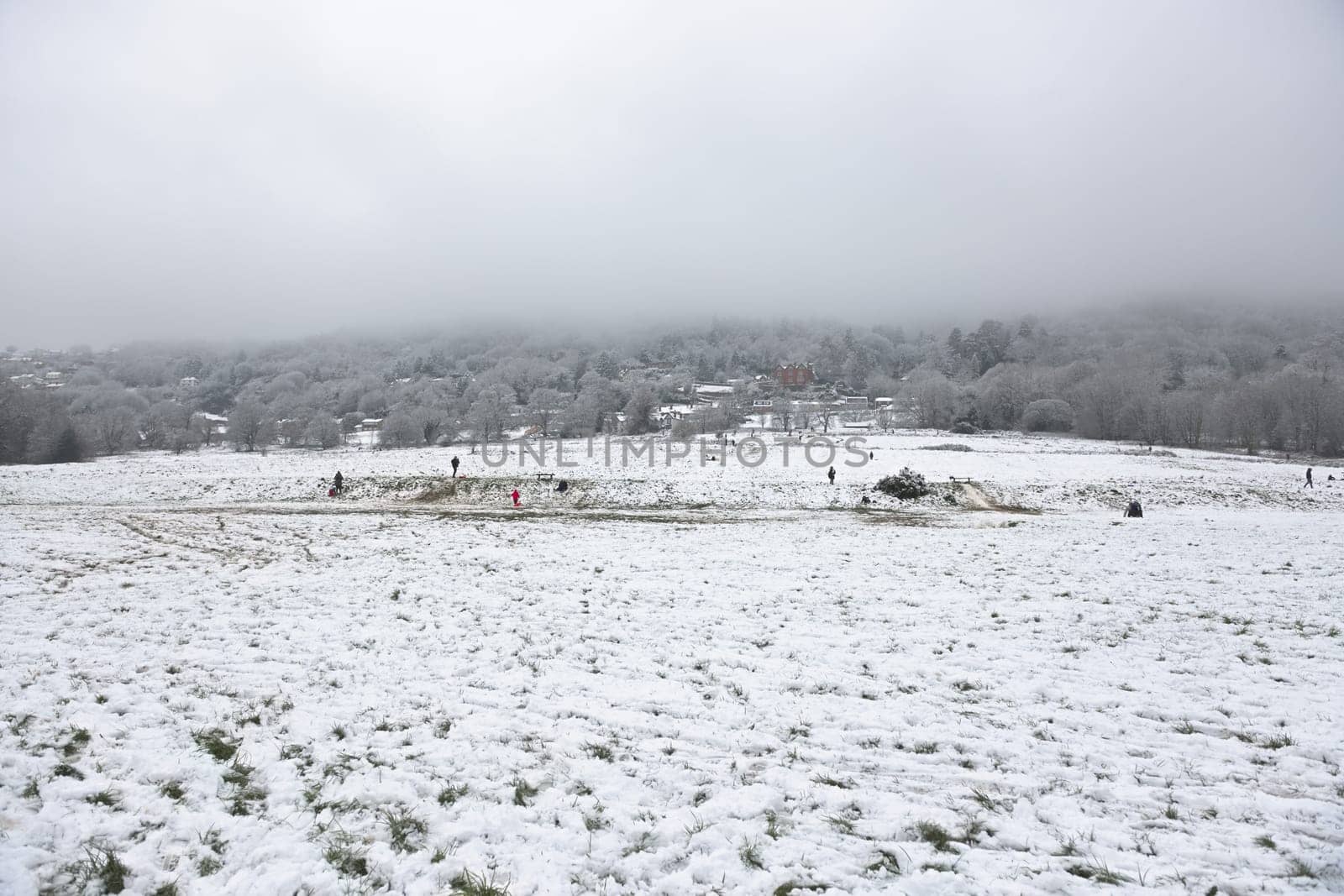 Malvern, United Kingdom, 28th December, 2020: Peachfield road car park and football pitch area at the base of malvern hills. People enjoy fresh snow.
