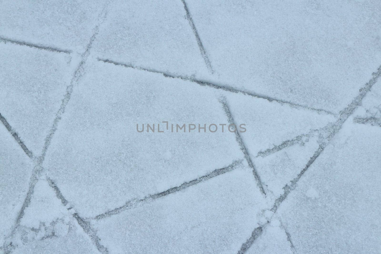 ice covered with snow lined skate tracks abstract white background