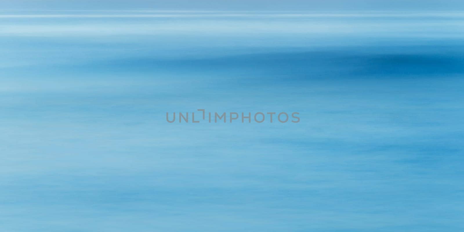 Long exposure of sea water and wave, full frame blue abstract background, shot at blue hour