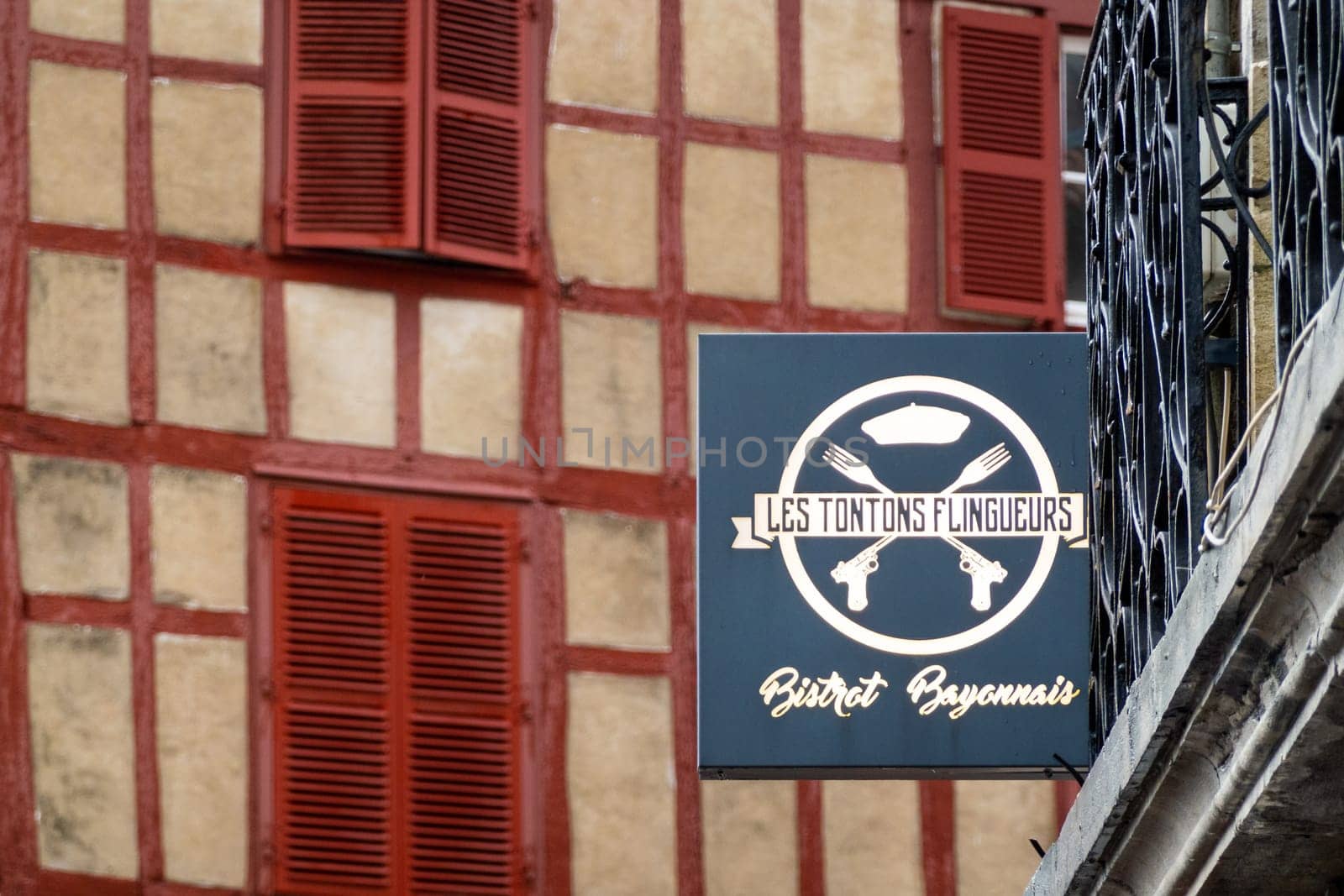 BAYONNE, FRANCE - CIRCA DECEMBER 2020: Les Tontons Flingueurs restaurant sign. The name comes from a movie from the same name.