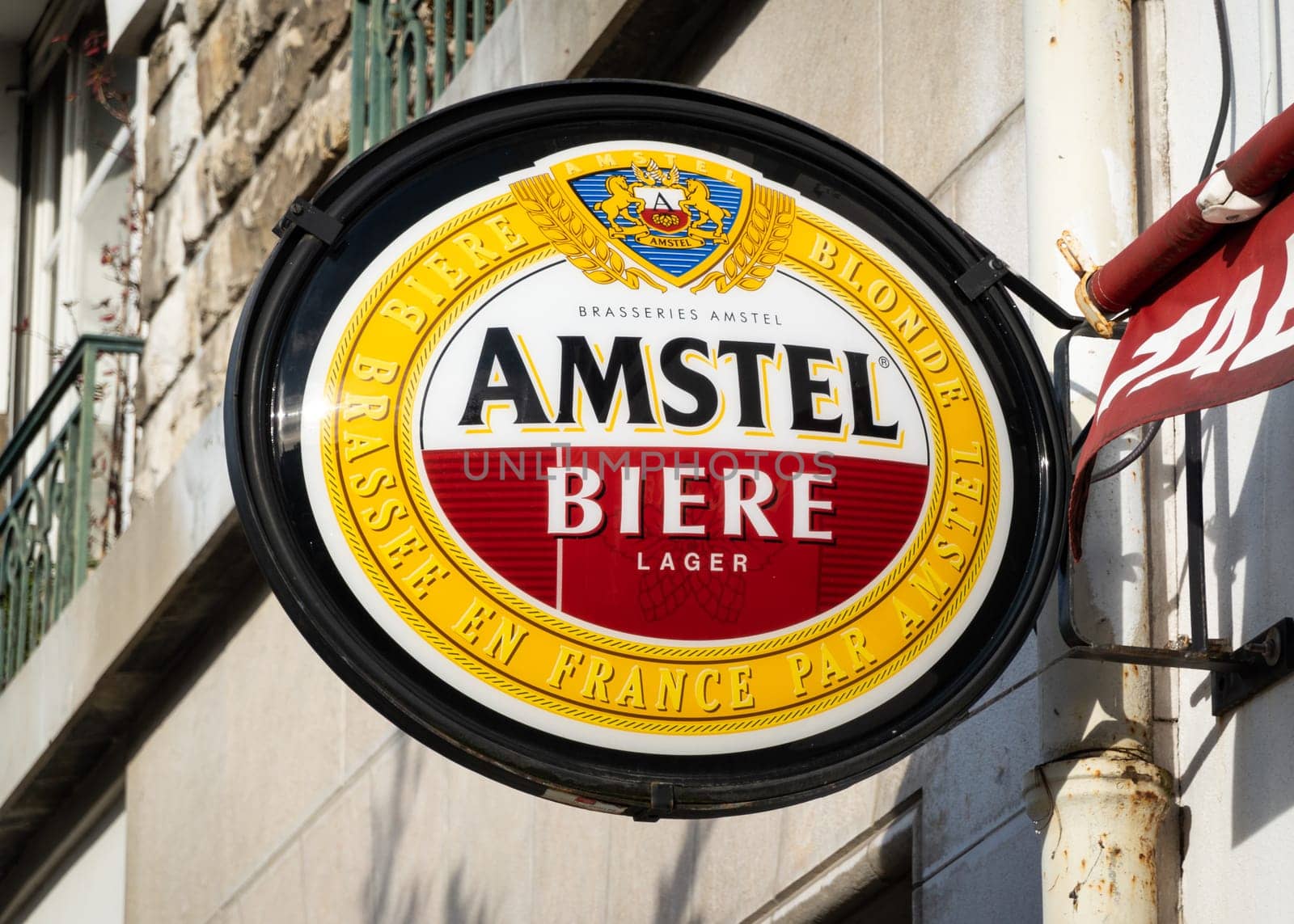 BAYONNE, FRANCE - CIRCA DECEMBER 2020: Amstel sign outside a cafe. Amstel Brewery is a Dutch company owned by Heineken International.