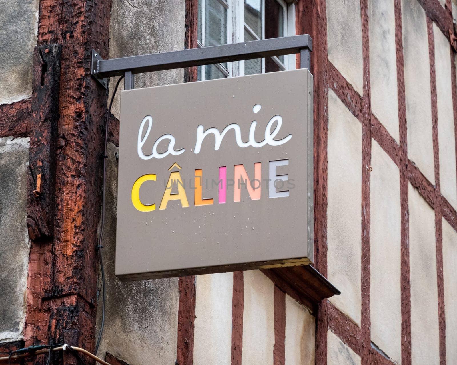 BAYONNE, FRANCE - CIRCA DECEMBER 2020: La Mie Caline sign. La Mie Caline is a French bakery chain. A few rain drops on the sign.