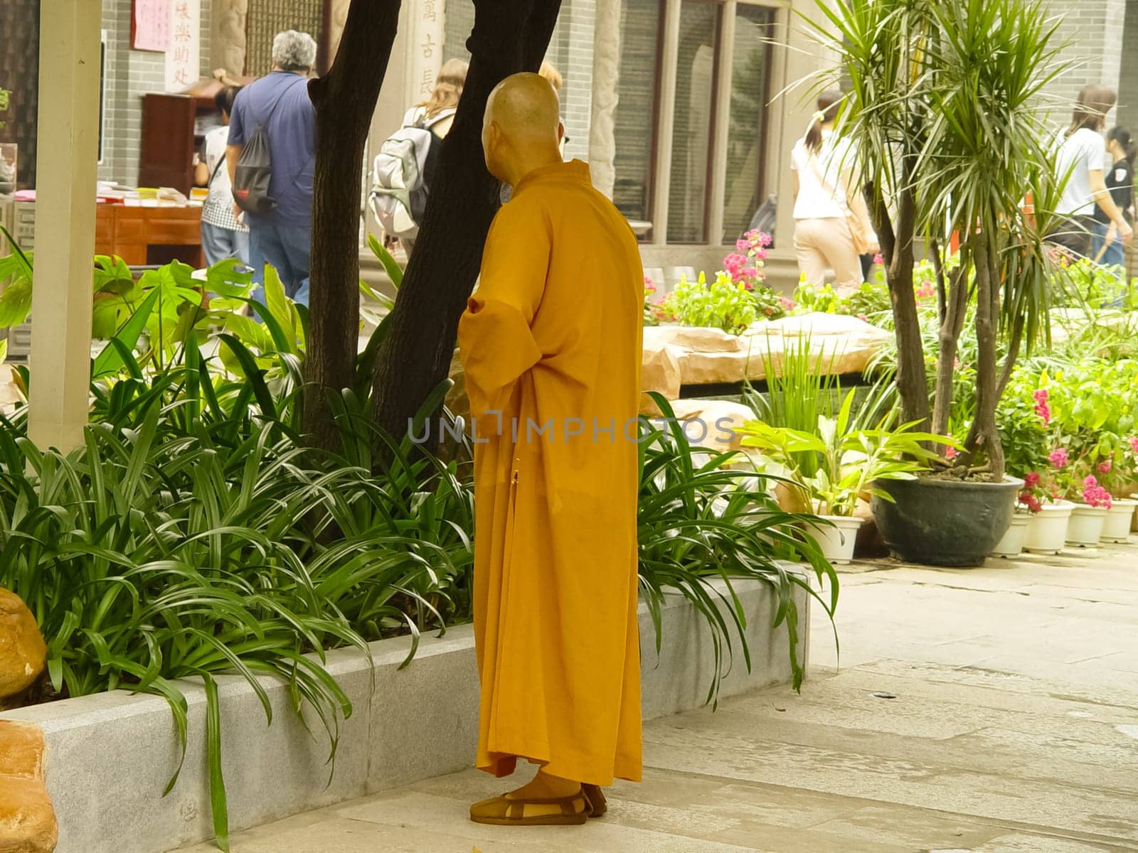 Hong Kong, China - June 24, 2019: A Buddhist monk on a Hong Kong street. A cult servant.