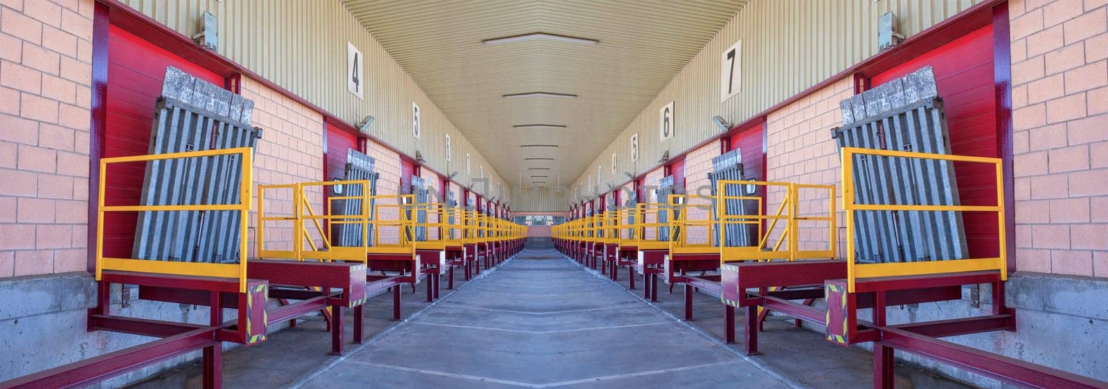 Truck loading docks at commercial building. Overhead door, dock leveler, and dock seals
