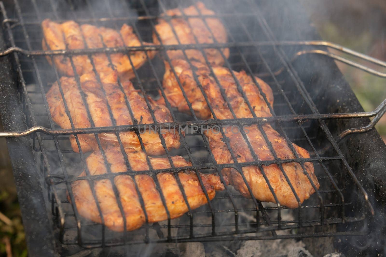 Delicious meat, grilled on a grill with a delicious crust cooked in the open air