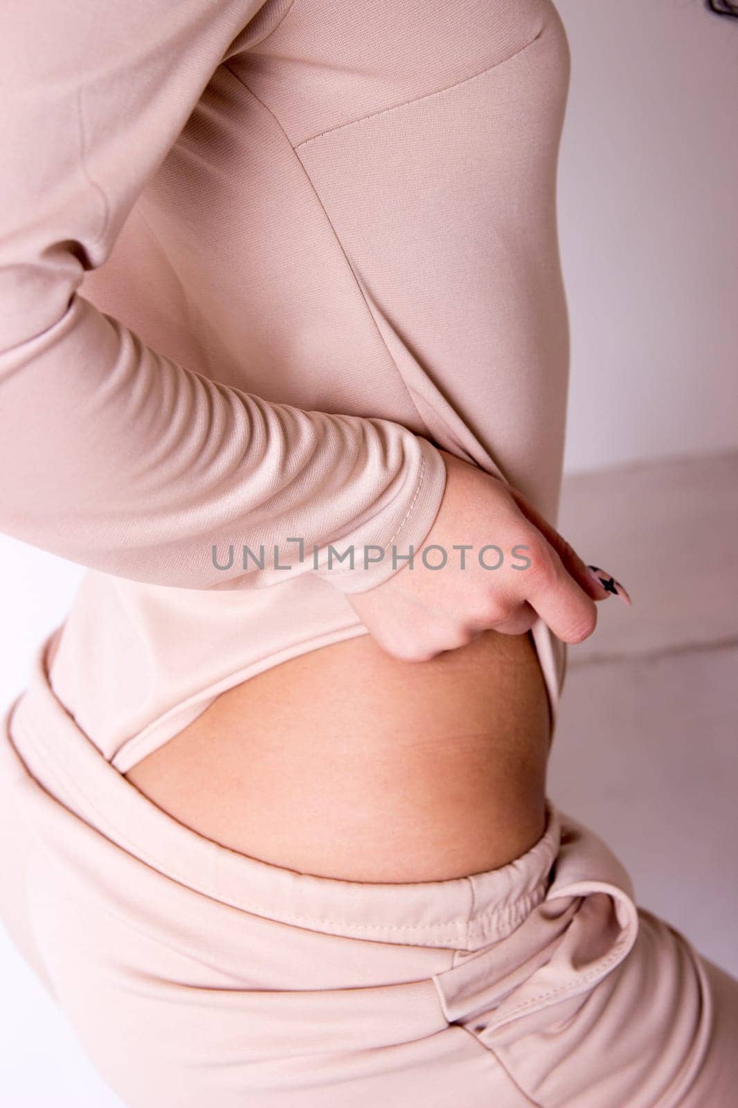 Model posing girl in jeans with a slim figure shows a thin stomach