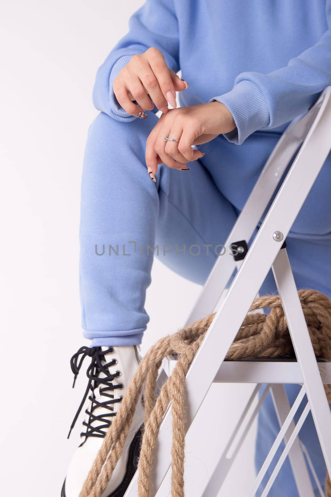 Female sneakers. White female shoes on feet.