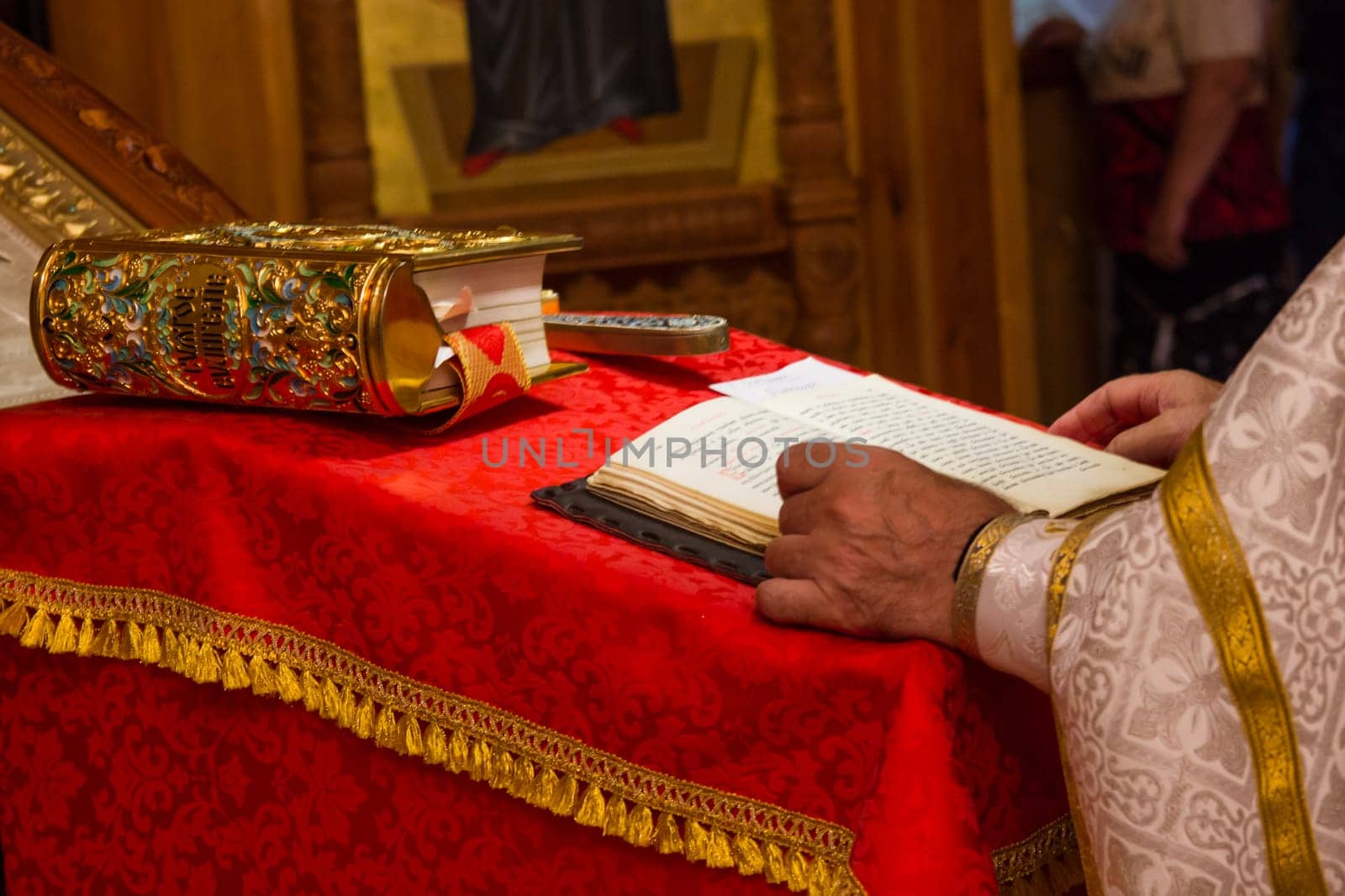 A priest holding the Bible at a christian ritual. Christian celebraton