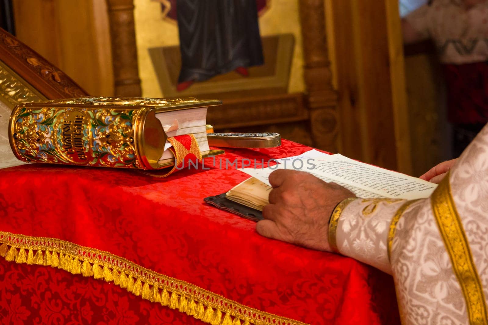 A priest holding the Bible at a christian ritual. Christian celebraton