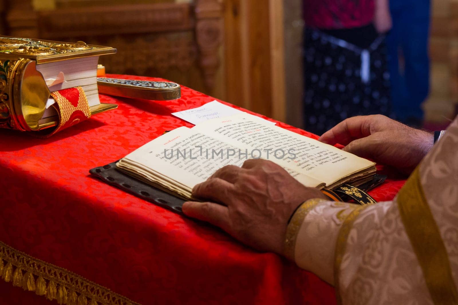 A priest holding the Bible at a christian ritual. Christian celebraton