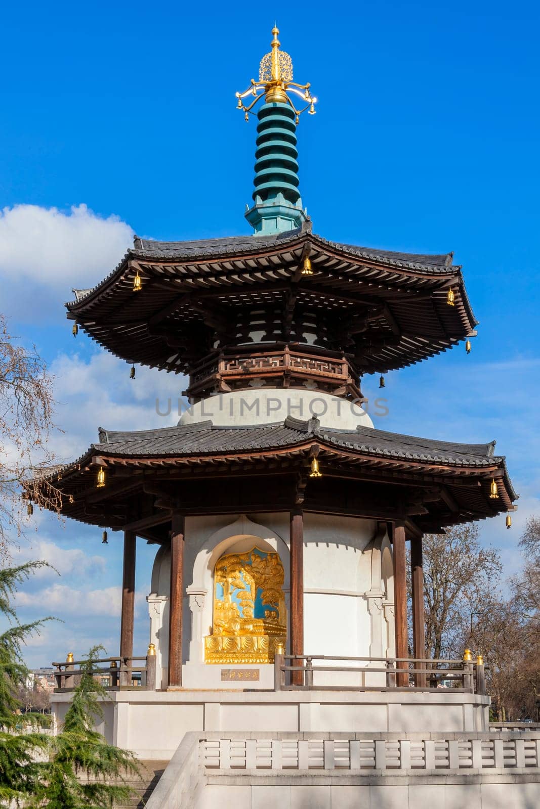 The Peace Pagoda in Battersea Park London England with gilded bronze gold Buddha statues which is a popular travel destination tourist attraction landmark of the city, stock photo image