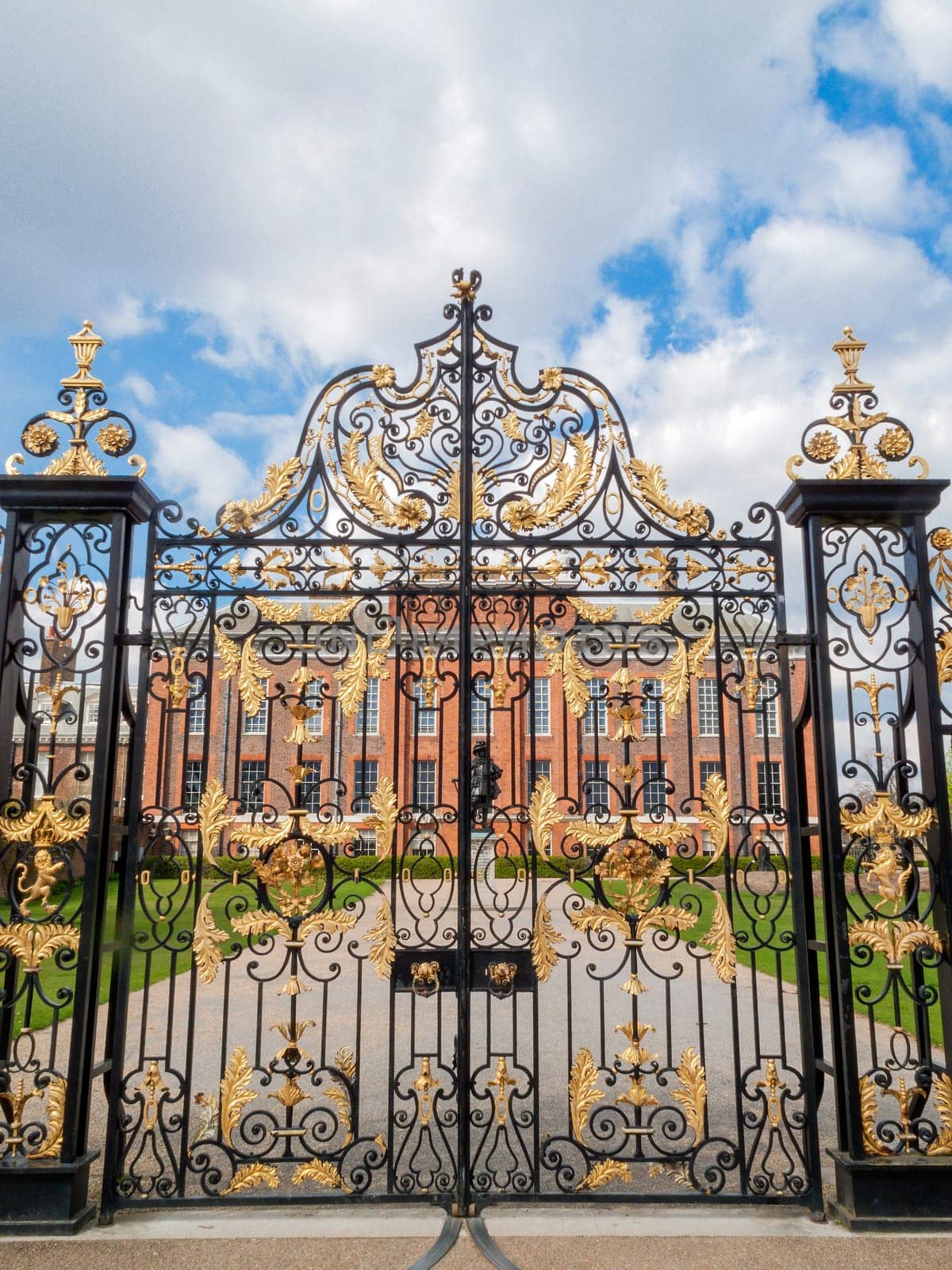 Kensington Palace gates in Kensington Gardens London England UK which was designed by Sir Christopher Wren for William III in 1689 and is a popular travel destination tourist attraction landmark