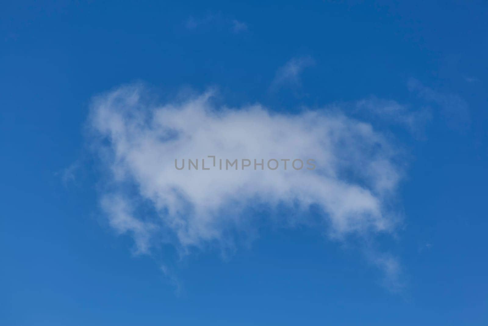 Background of a one single cumulus cloud with a blue clear sky
