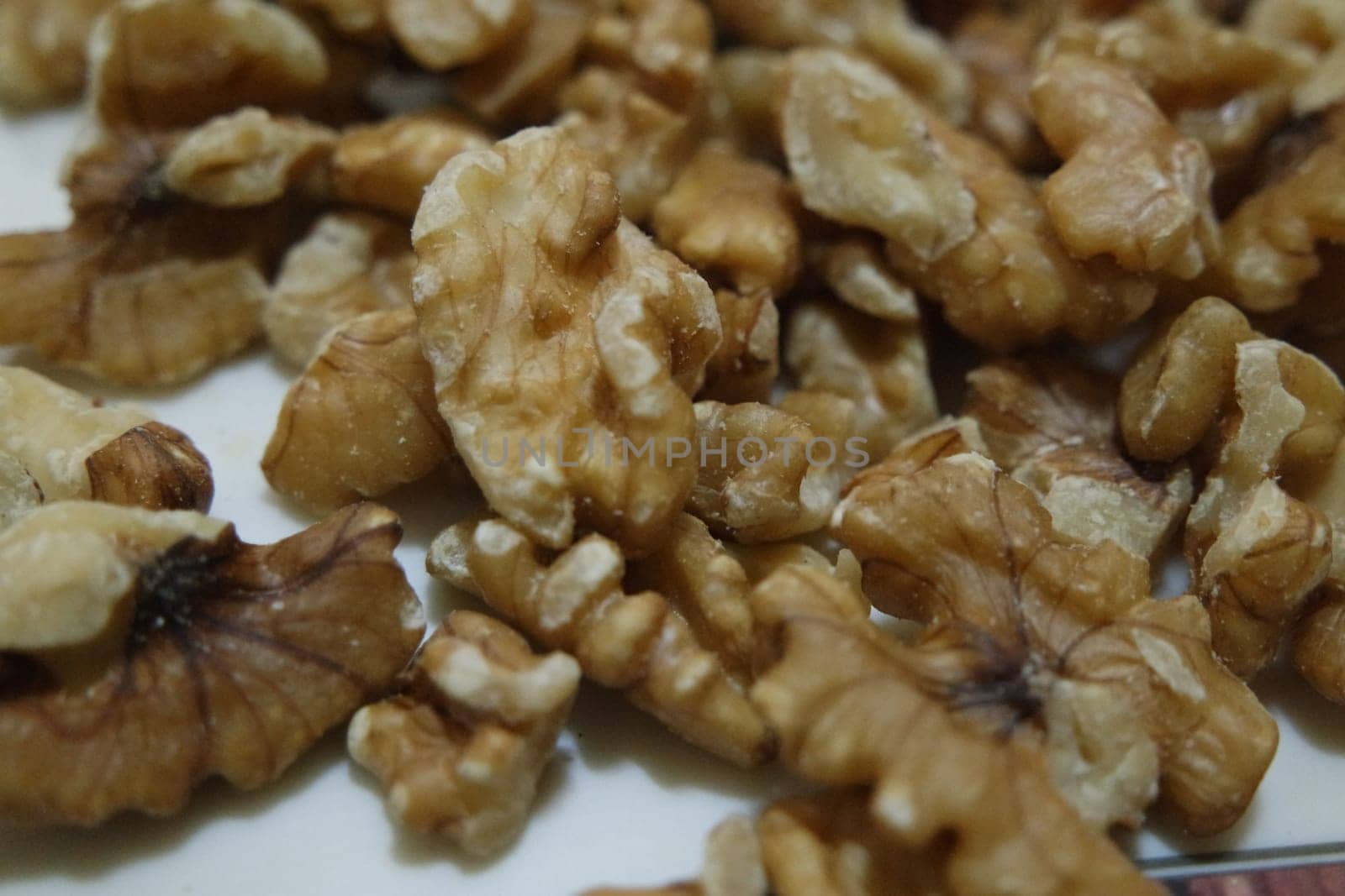 Close-up top view of peeled walnut on a white background. peeled walnut without shell ready to eat dry fruit.