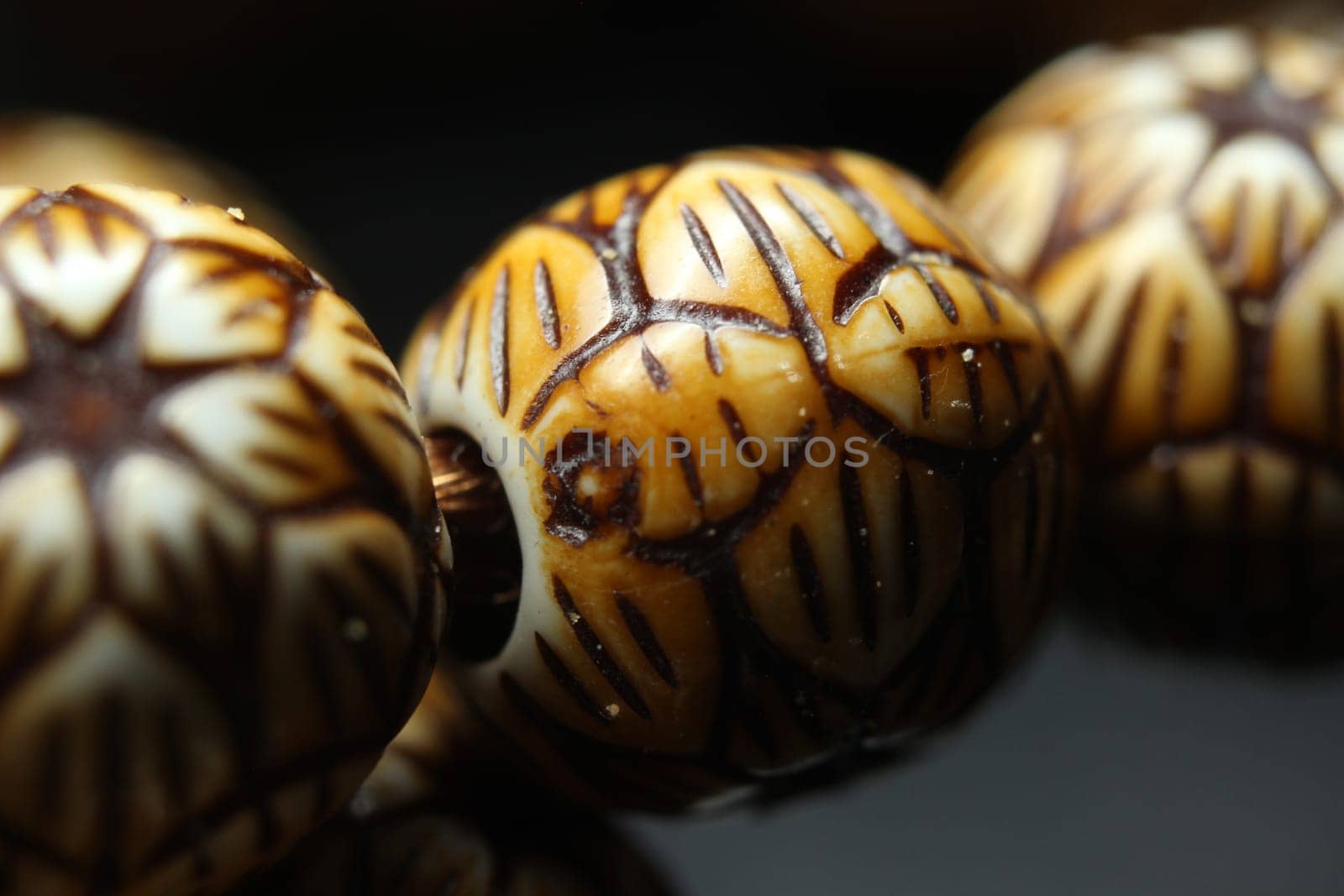 Beautiful wooden prayer beads or rosary with a striped background. Religion concept of ramadan or Eid for muslims.