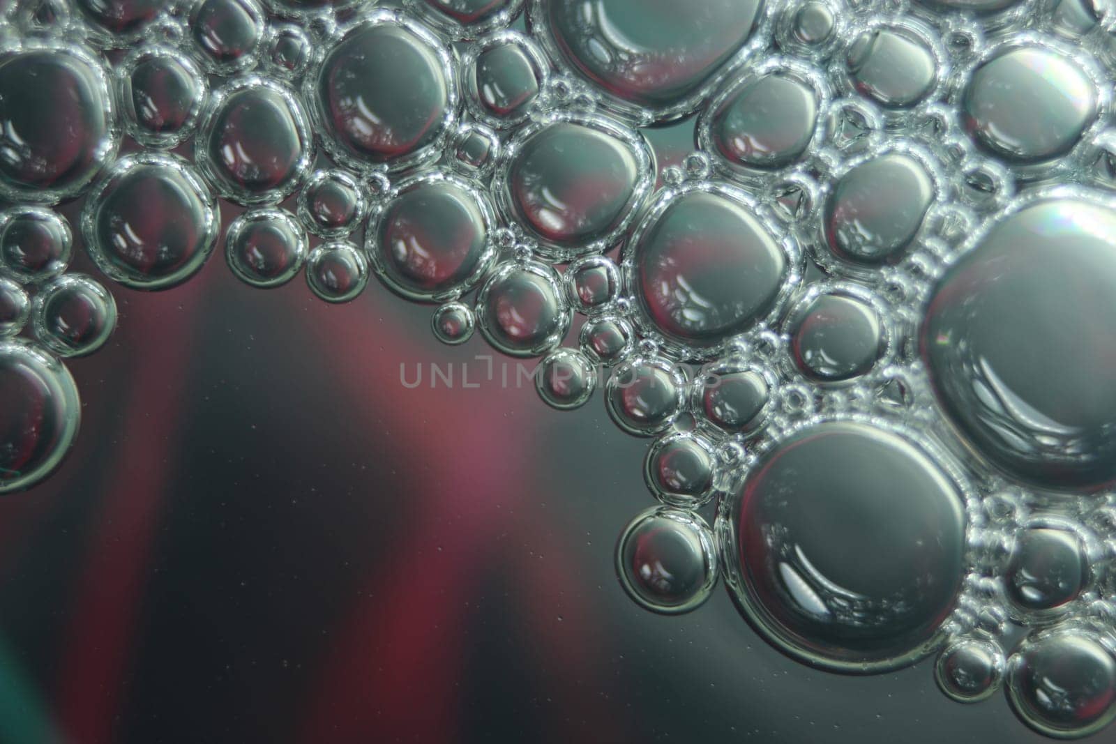 abstract macro background of oil circles floating over water surface . Macro closeup view of bubbles on water . oil bubbles in the water macro photographic background
