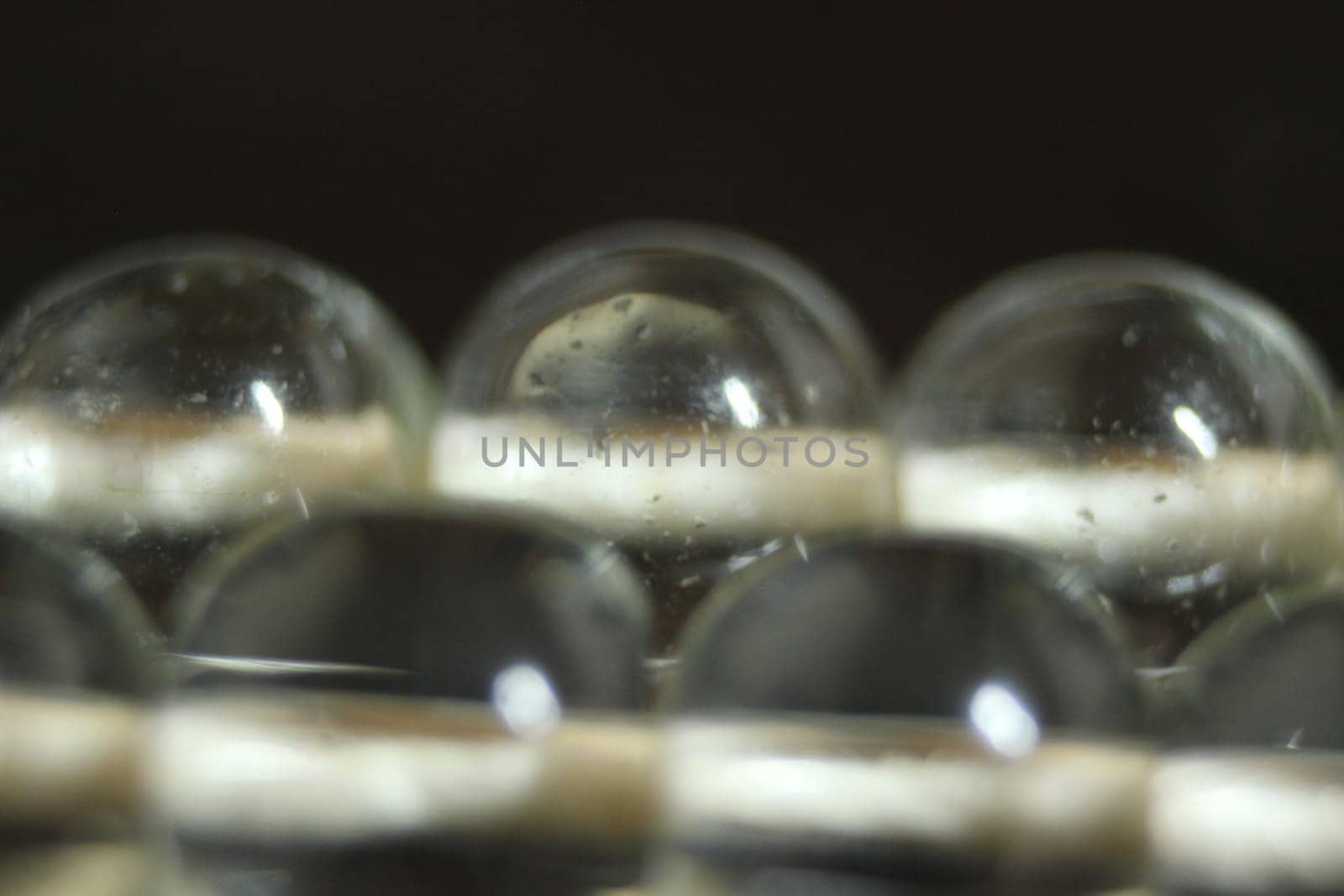 Macro photograph with selective focus of glass shiny prayer beads or rosary with copy space for text. Religion concept of ramadan or Eid for muslims.