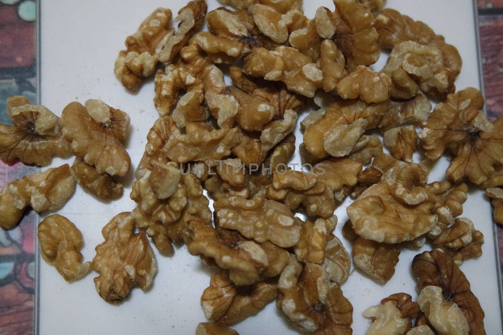 Close-up top view of peeled walnut on a white background. peeled walnut without shell ready to eat dry fruit.