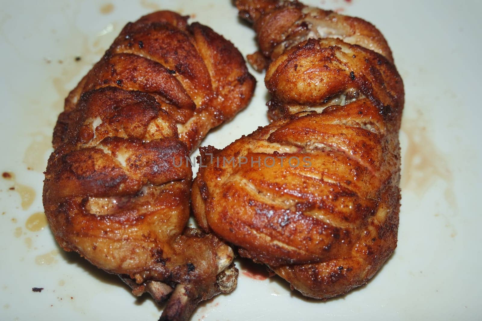 Fried, grilled baked chicken pieces with marinated spices on it. Tasty delicious fried chicken barbecue