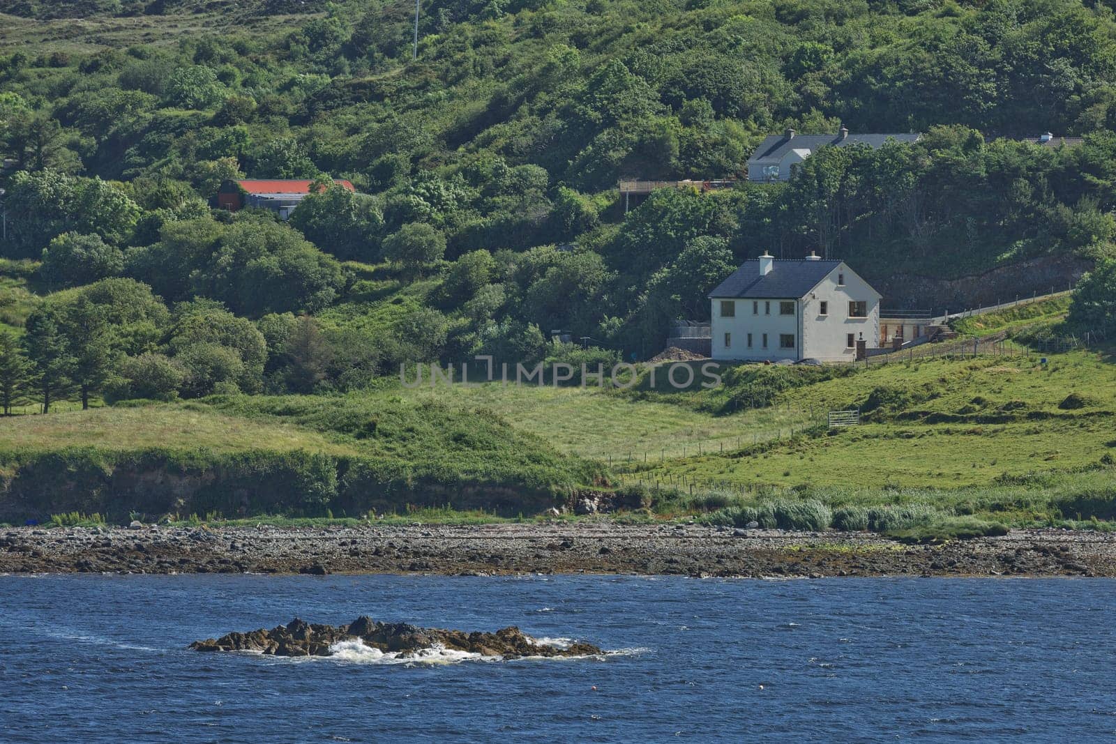 People enjoying living in beautiful landscape full of rock formations along the irish coastline near Killybegs, County Donegal in Ireland.
