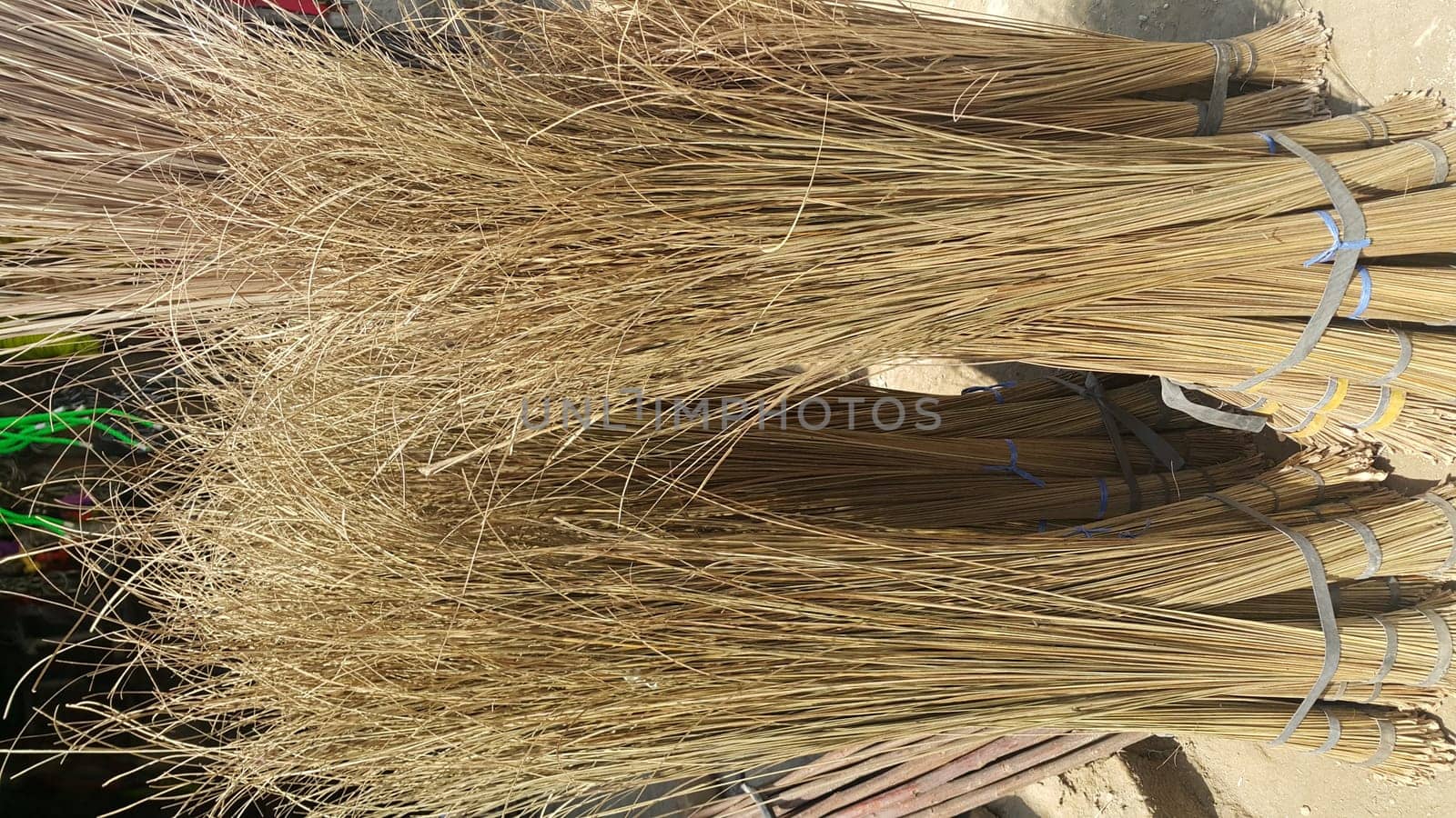Bunch of brown colored straw broom. Old style broom used for housekeeping in rural area in Asian countries.