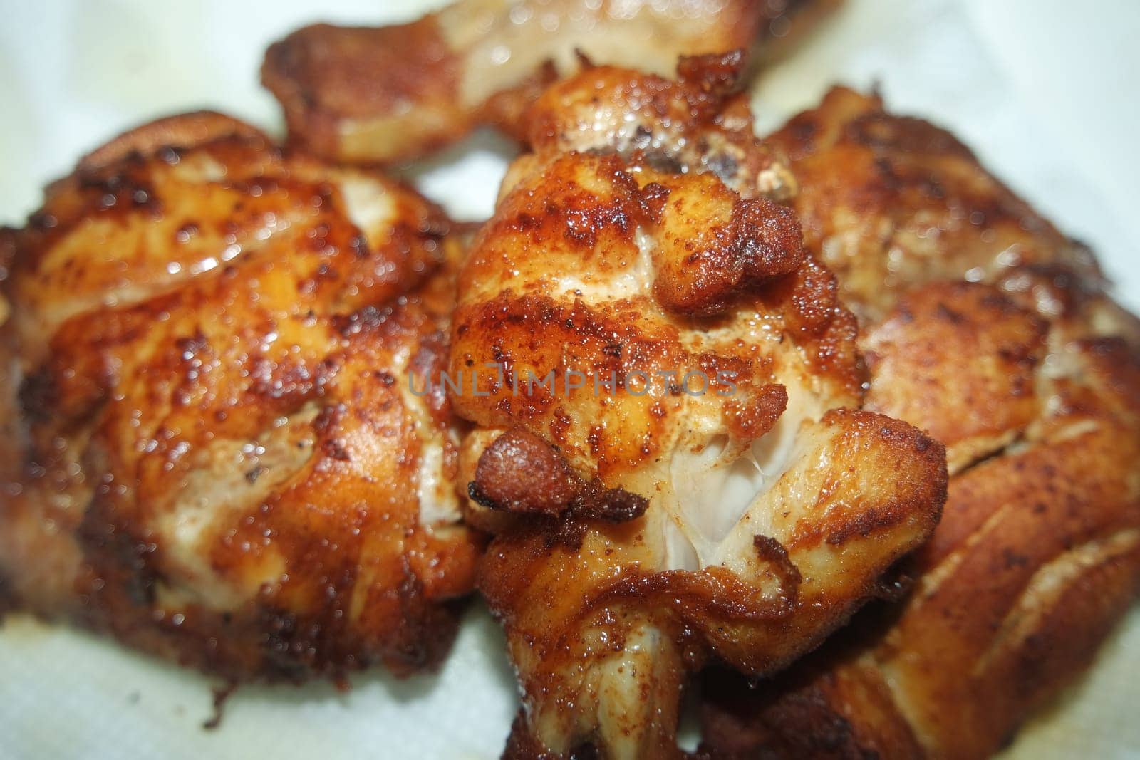 Fried, grilled baked chicken pieces with marinated spices on it. Tasty delicious fried chicken barbecue