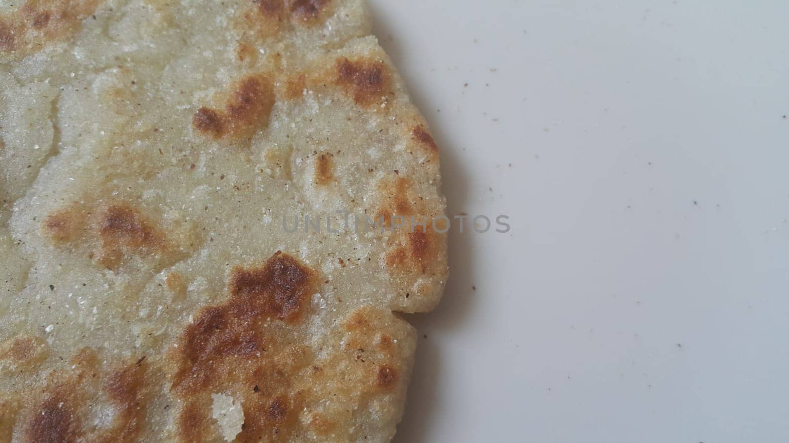 Closeup view of of traditional bread called Jawar roti or bhakri on white background. Bhakri is a round flat unleavened bread often used in the cuisine of many Asian countries