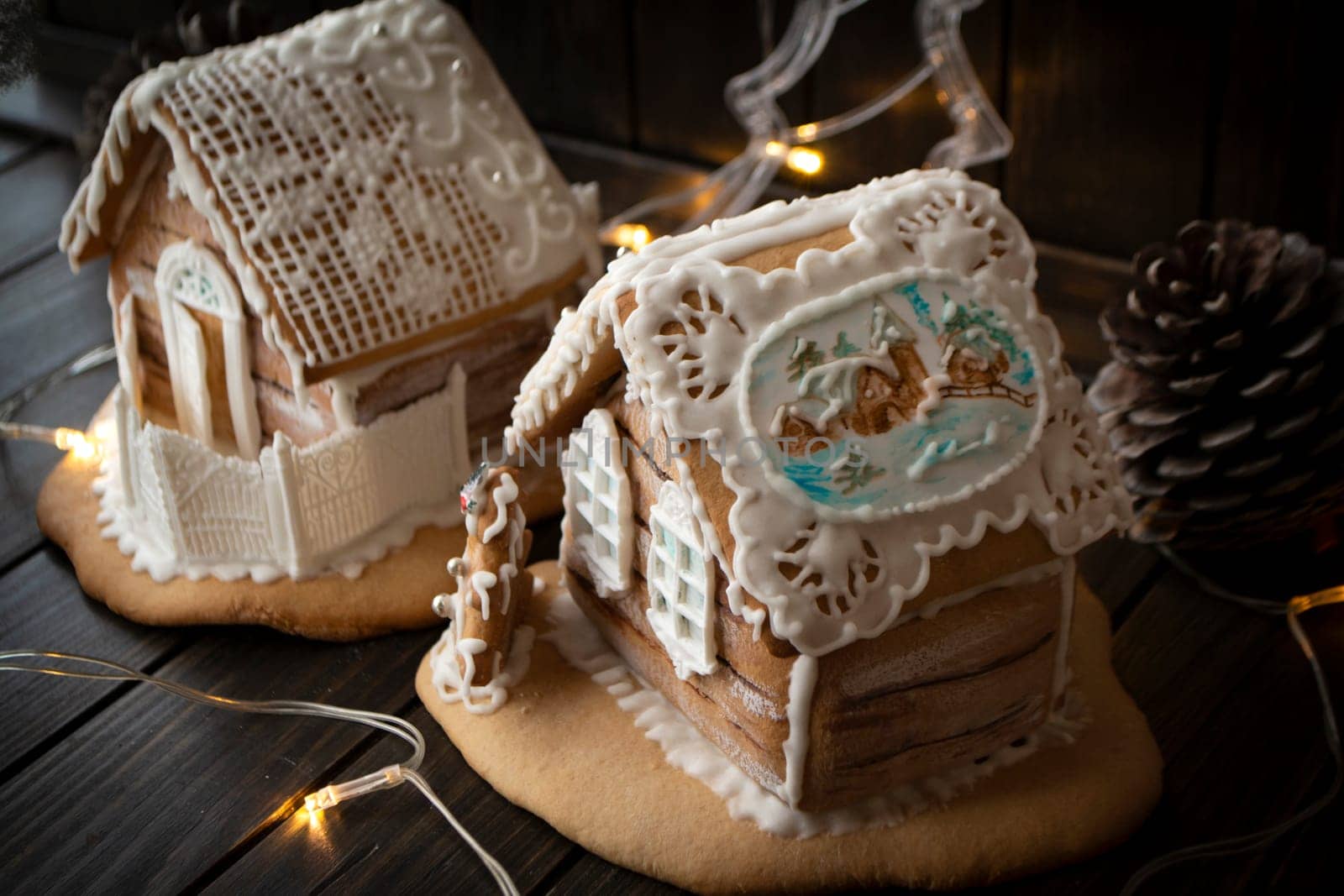 Gingerbread house with chrismtas decorations and lights in background