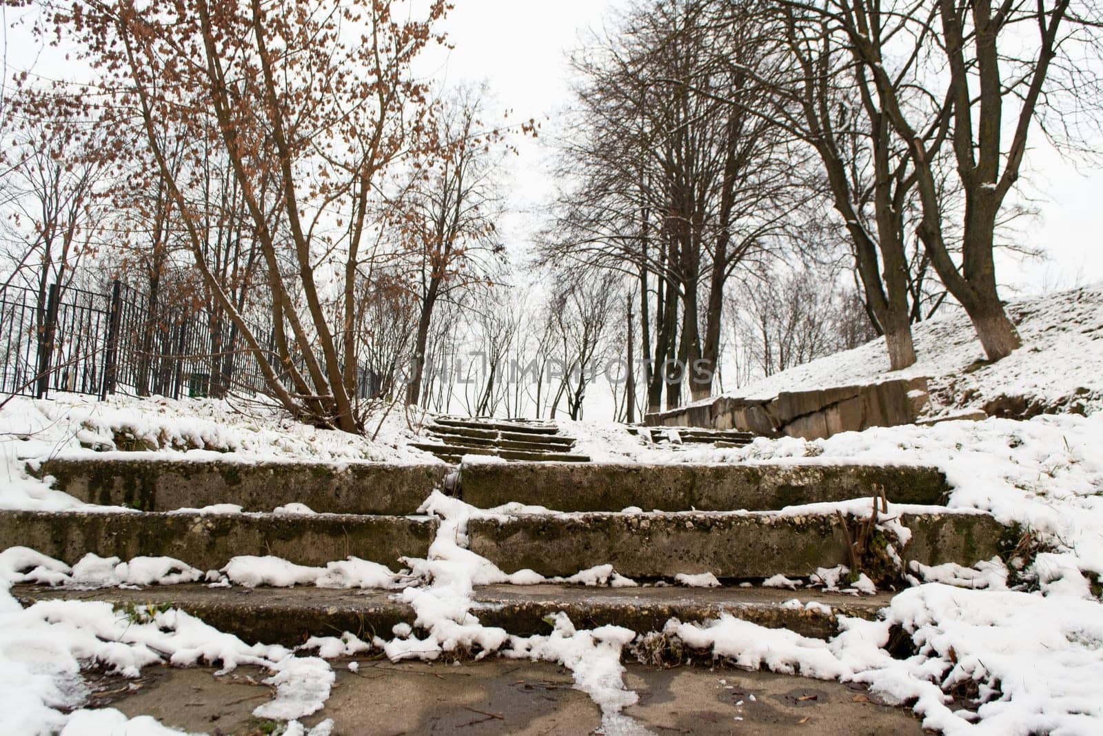 Stone concrete snow covered stairs in the city at winter. Stairway to heaven. Black and white