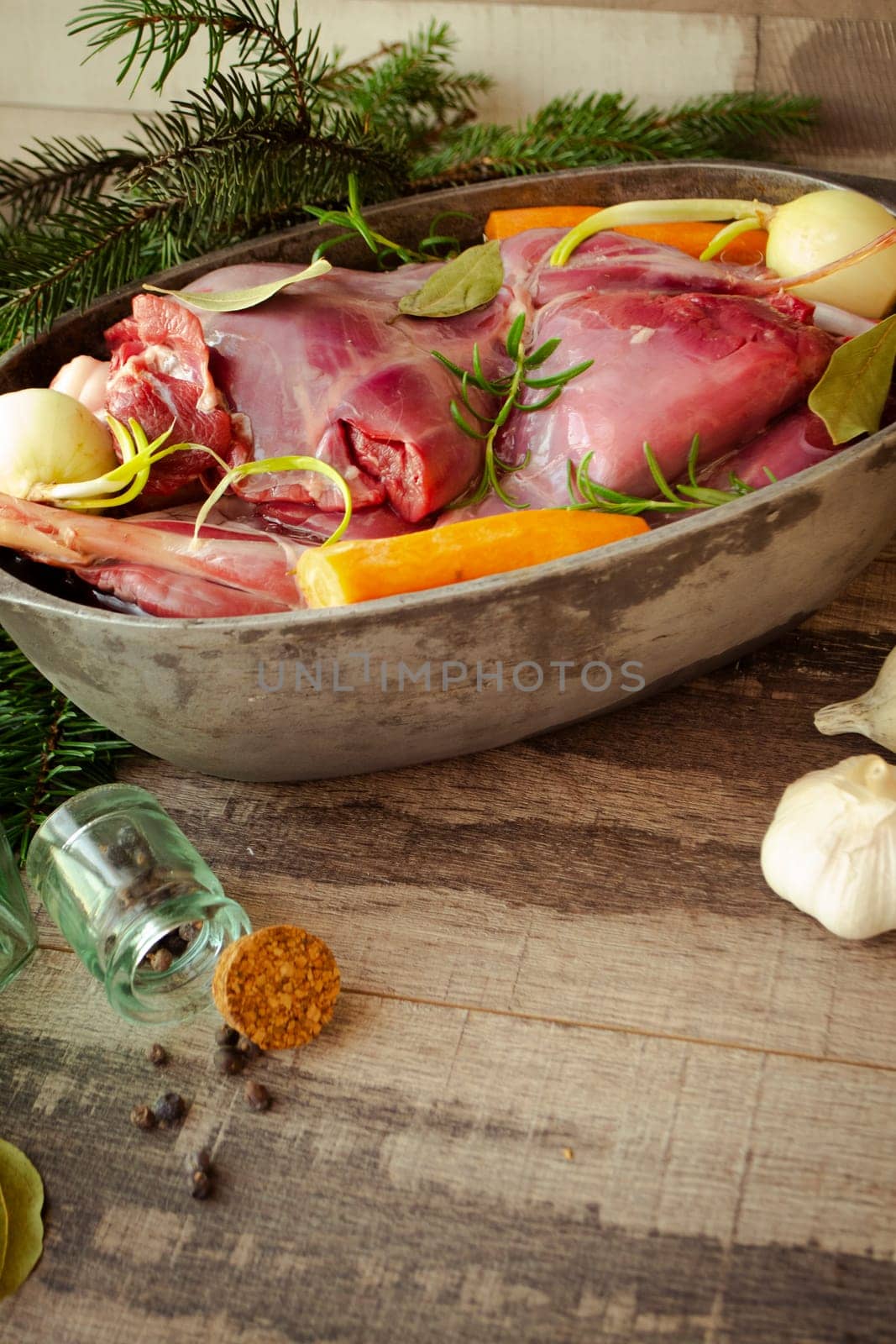 Venison goulash stew in pot with hare and rabbit, vertical image