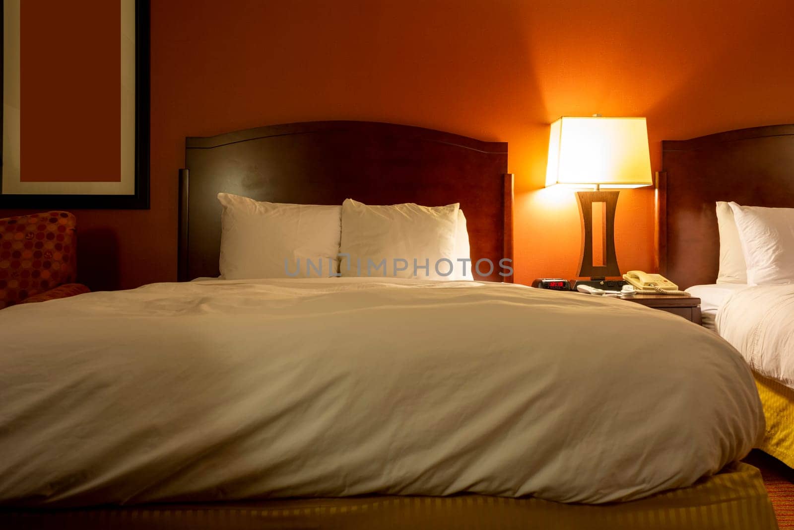 View of a comfortable hotel room with warm and relaxing colors.