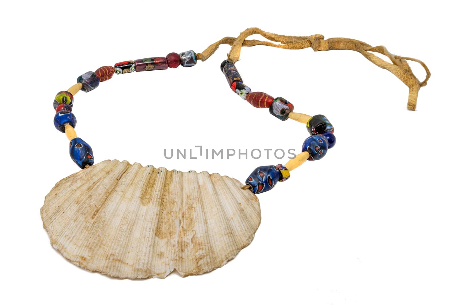 Indian necklace with a large seashell and old glass beads on a leather cord isolated on white