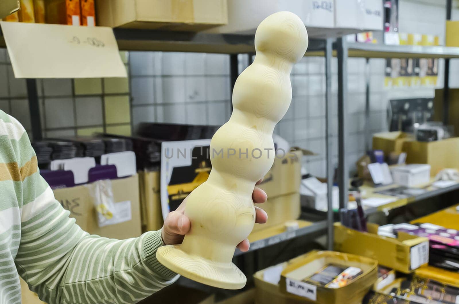 Rubber products factory for a sex shop. Workers process rubber penises. Reduction to the presentation of products. Sex toys.