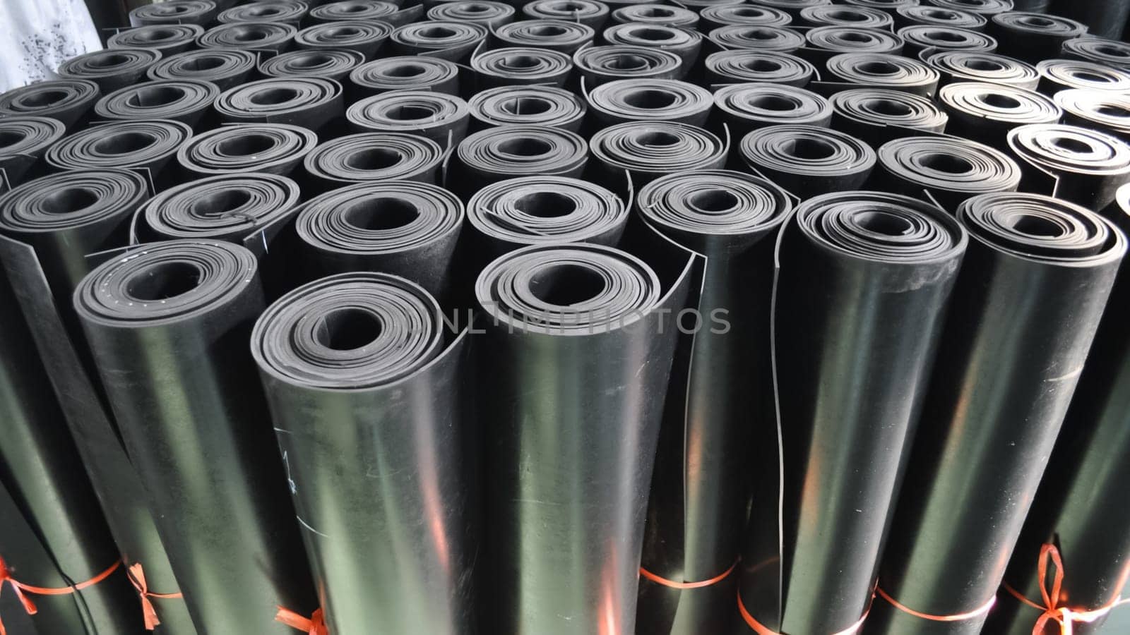 warehouse rolls of rubber. black coating rolls.