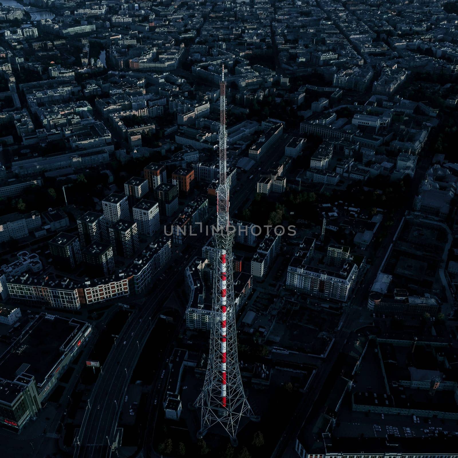 High communications tower in a residential area. Evening.