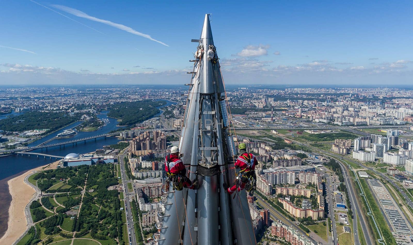 Workers installers at the height work at the top of the skyscraper.