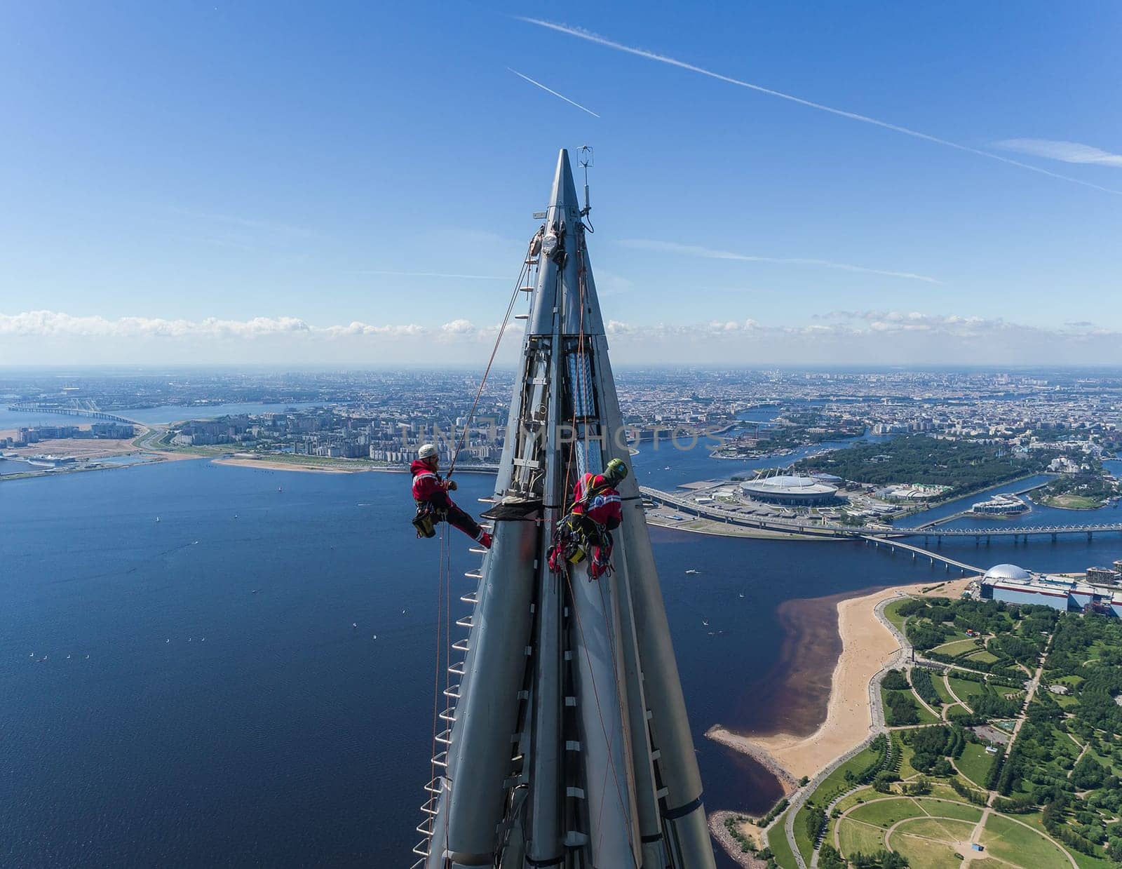 Workers installers at the height work at the top of the skyscraper.