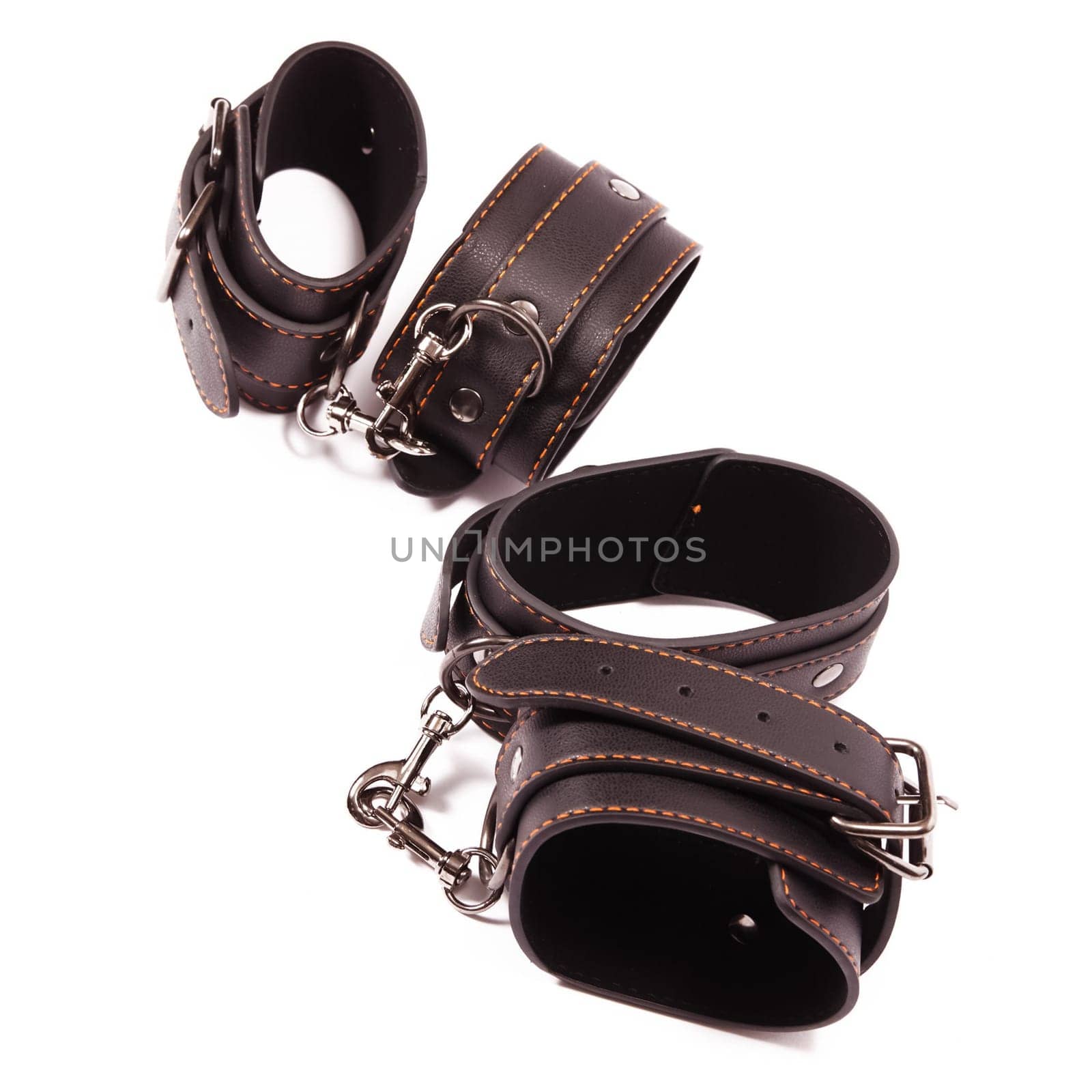 Black leather handcuffs. A toy for BDSM.