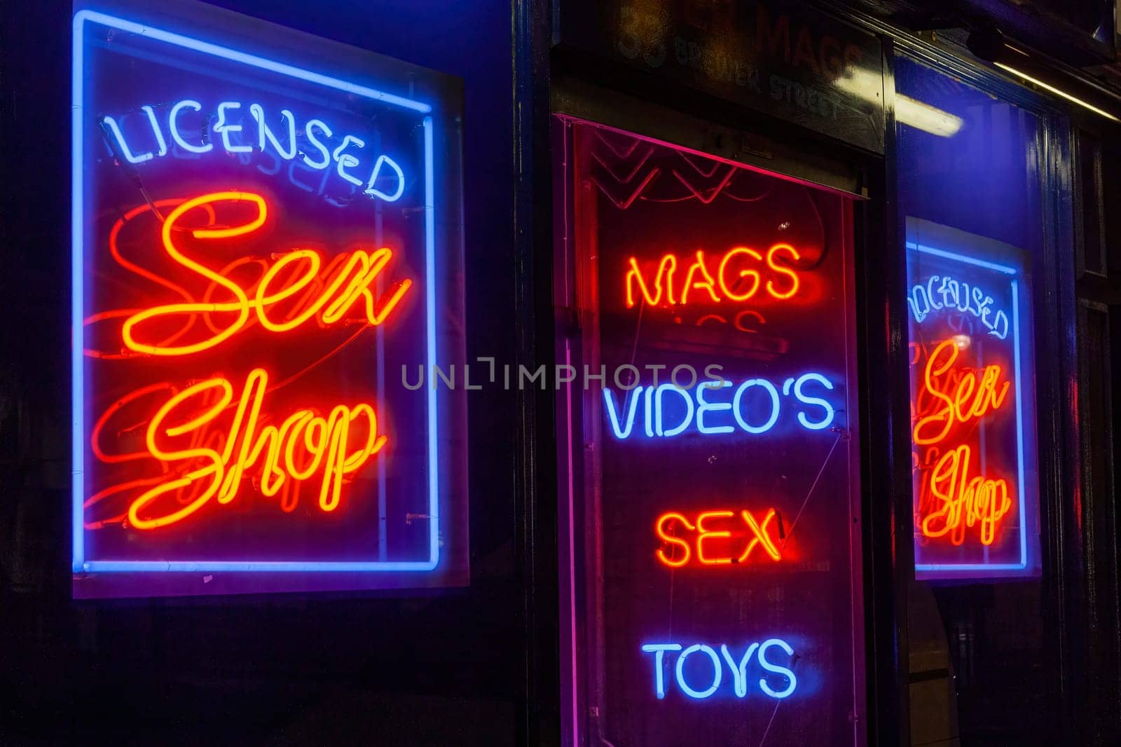 Sex shop neon sign advertising an adult licensed business in the Soho red light district industry, stock image photo
