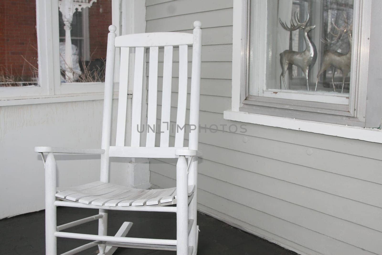 Vintage white rocking chair on front porch