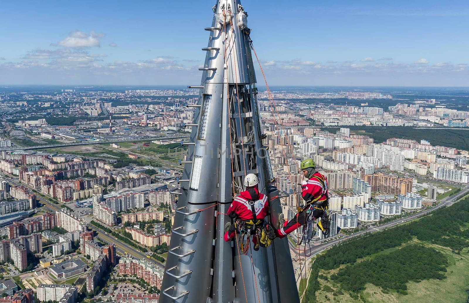 Workers installers at the height work at the top of the skyscraper.